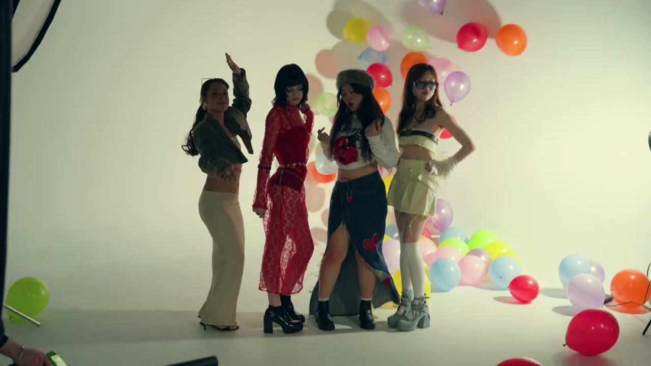 MARROLO, frame 01: four artists posing in front of a white cyc with balloons