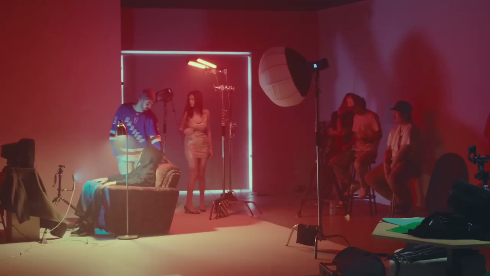 The crew working on a red set under studio lights