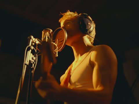 RAW 002, frame 10: the singer tilting his head up to the microphone, guitar in frame